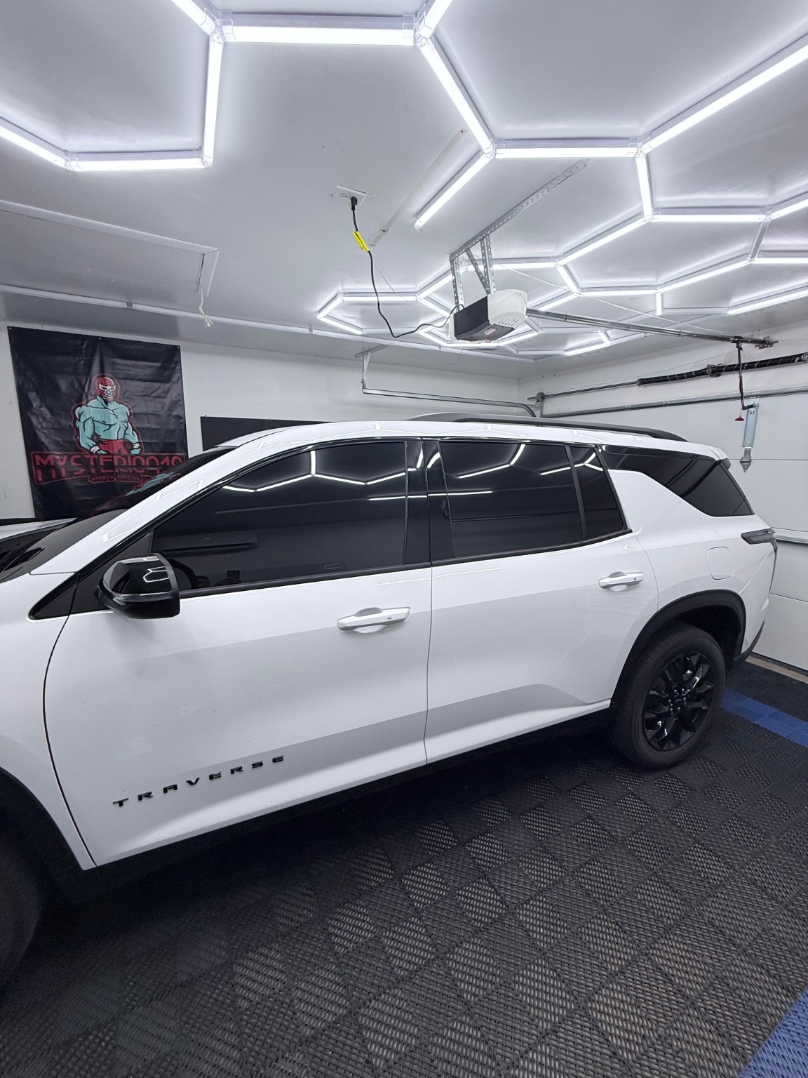 White Chevrolet Traverse with dark window tint