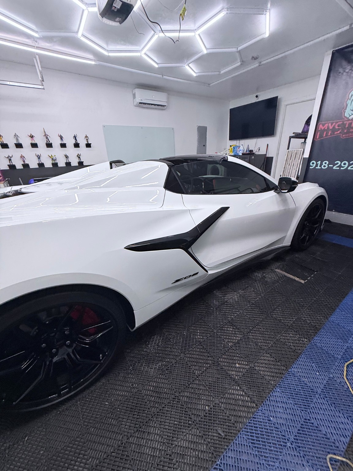 Premium window tint installation on a white Chevrolet Corvette